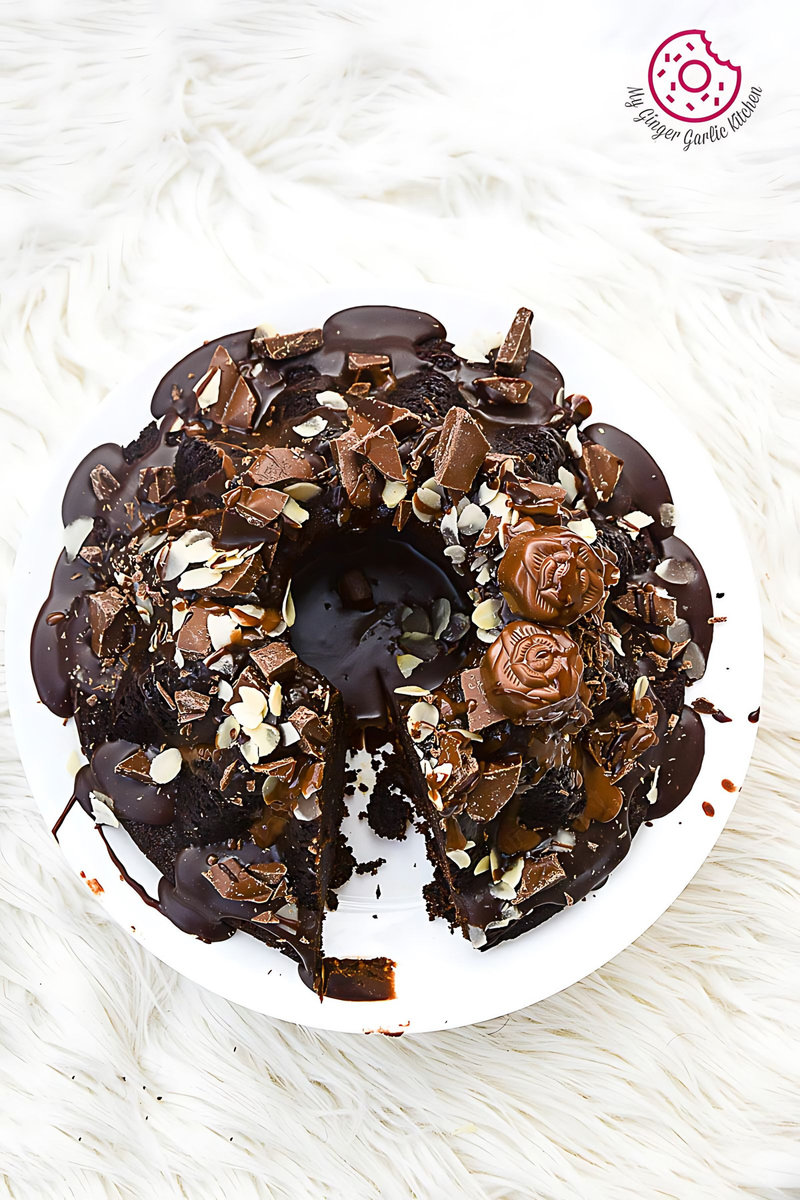 a plate of persimmon chocolate bundt cake on a white plate with chocolate frosting and nuts on it