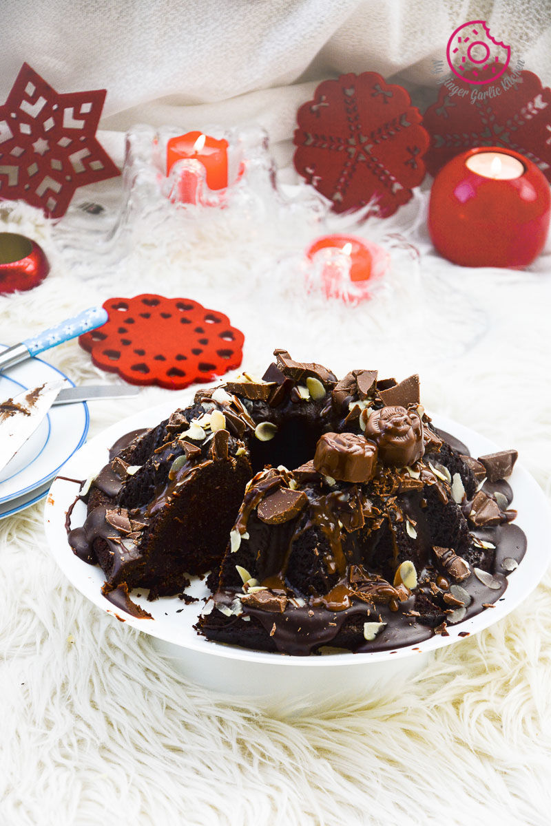 a plate of persimmon chocolate bundt cake on a white plate with chocolate frosting and nuts on it