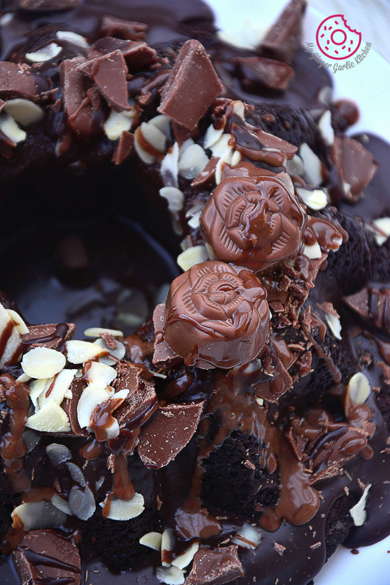 persimmon chocolate bundt cake with white and chocolate toppings on a plate