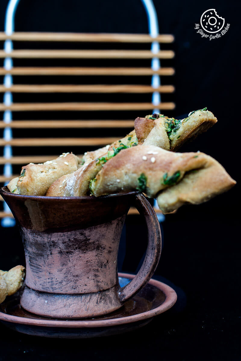 a cup of pizza dough twists with parsley