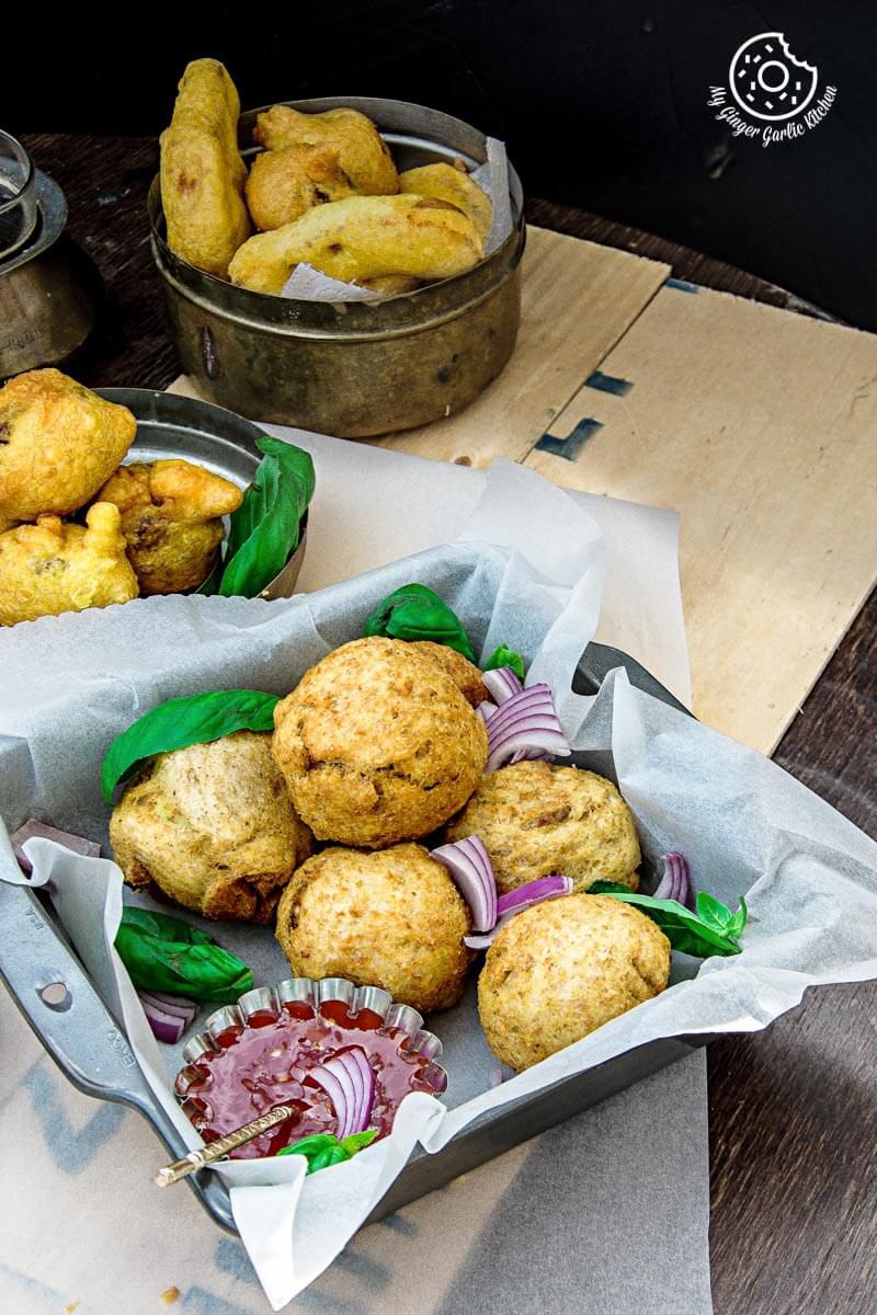 baskets of potato stuffed bread rolls on a table with more pakoras