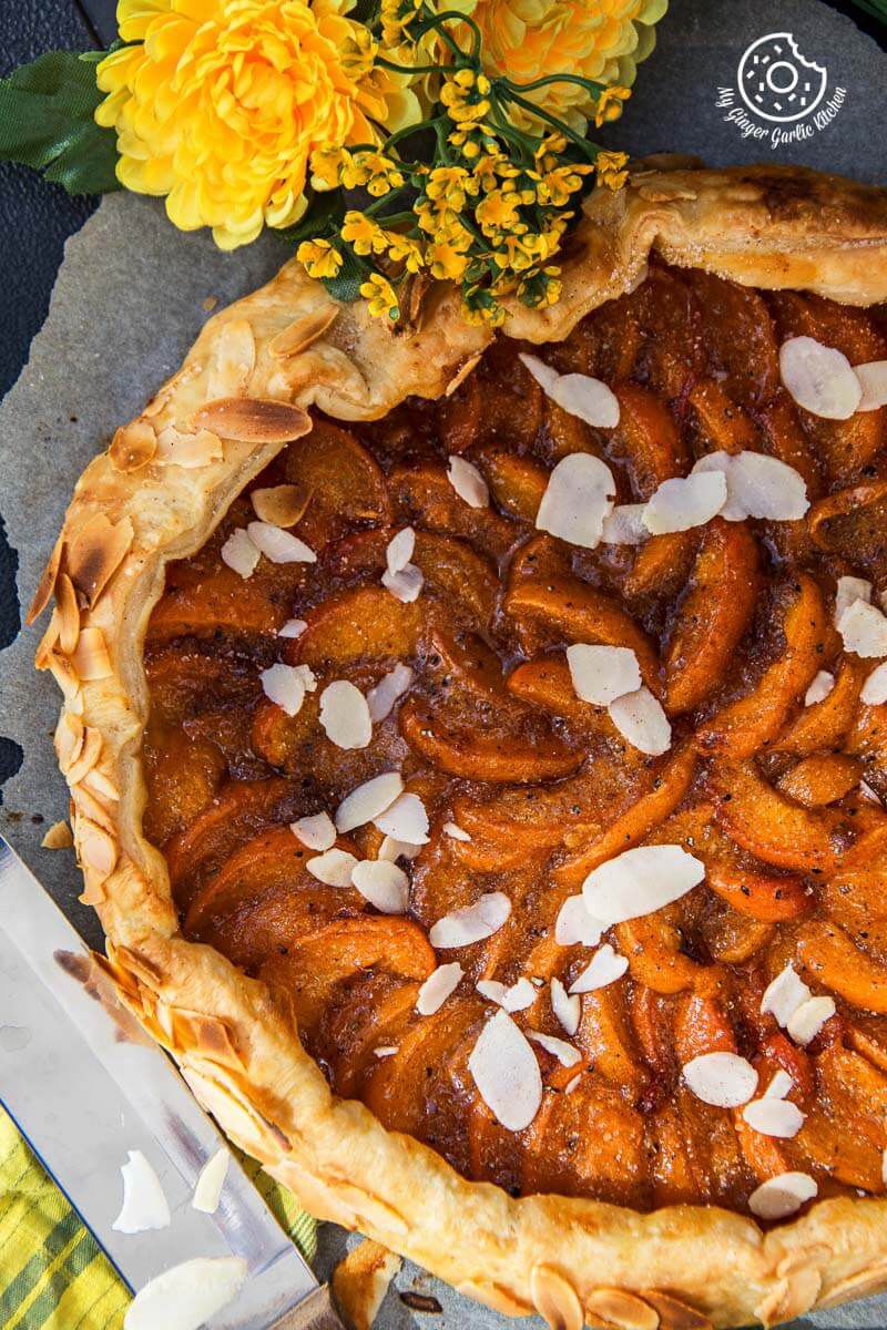 puff pastry apricot galette with almond toppings on it