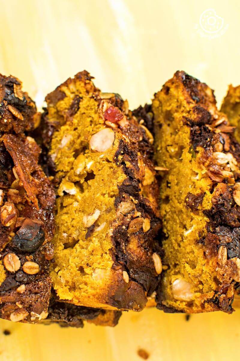 four slices of pumpkin muesli chocolate bread on a yellow plate