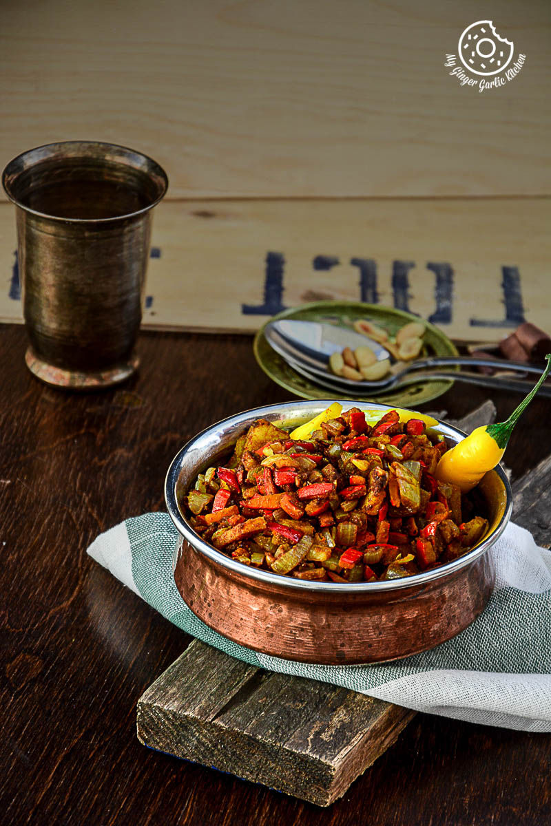 a bowl of pumpkin rind stir fry or kaddu ke chilke ki sabji on a table with a glass of water