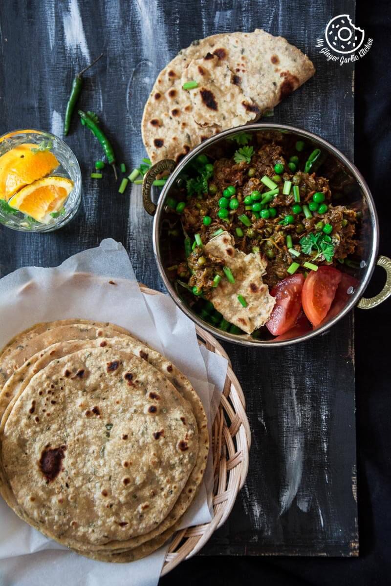 there is a plate of Punjabi Baingan Bharta that includes tortillas and a bowl of salsa