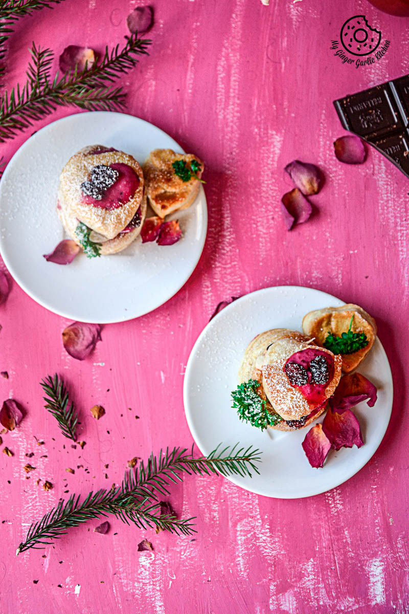 two plates of three raspberry creme fraiche and cookies puffs on a pink table