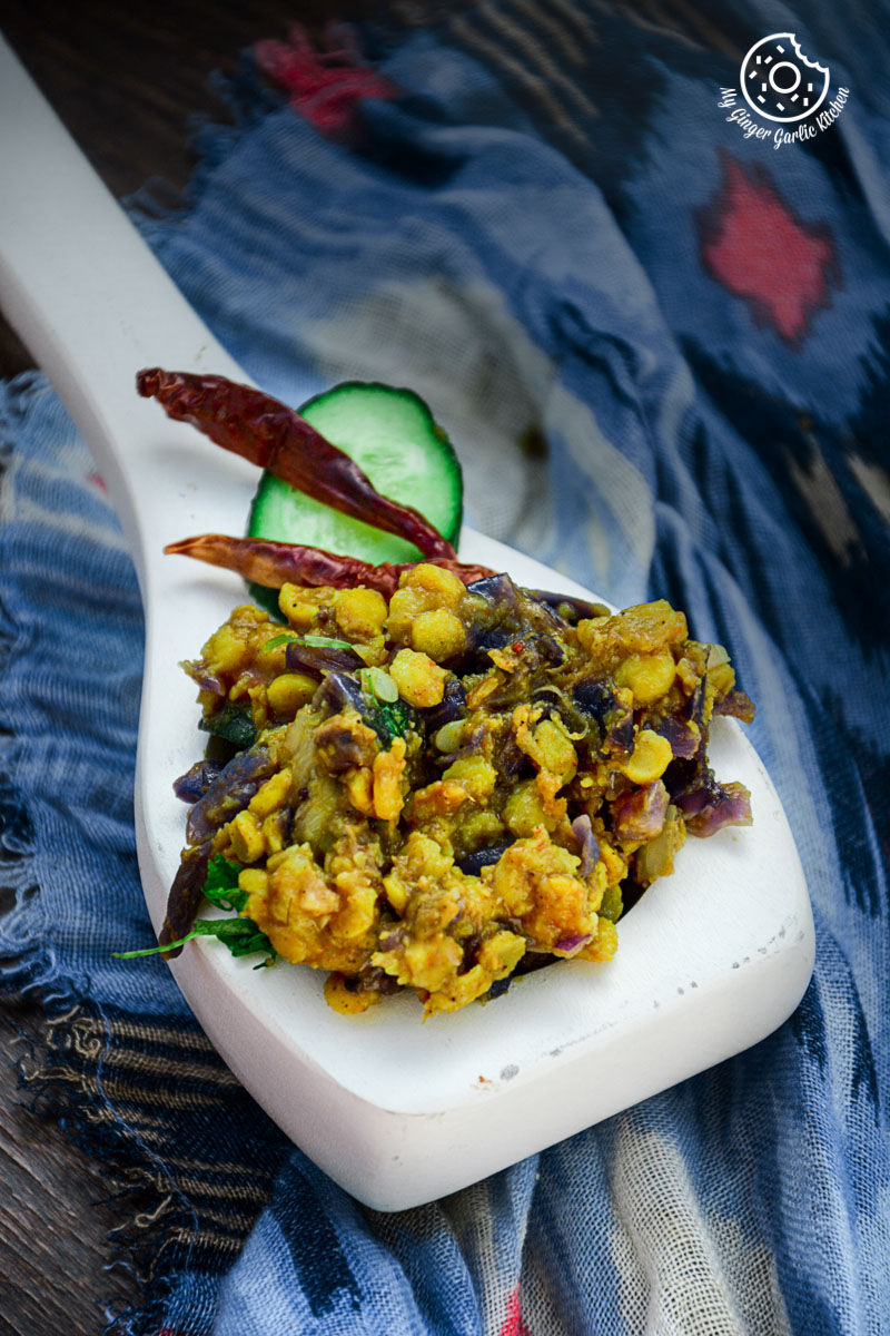 a spoon with red cabbage zucchini chana dal on it