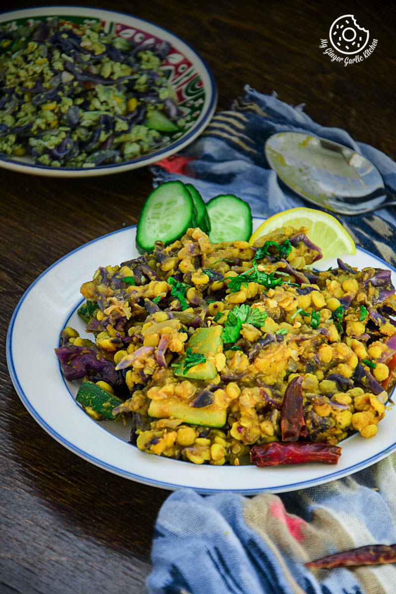 a plate of red cabbage zucchini chana dal that is on a table