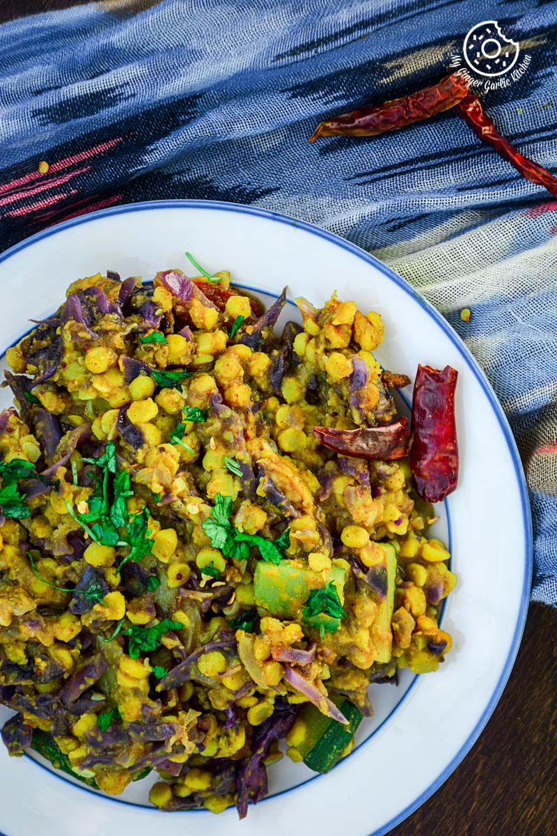 a plate of red cabbage zucchini chana dal that is on a table