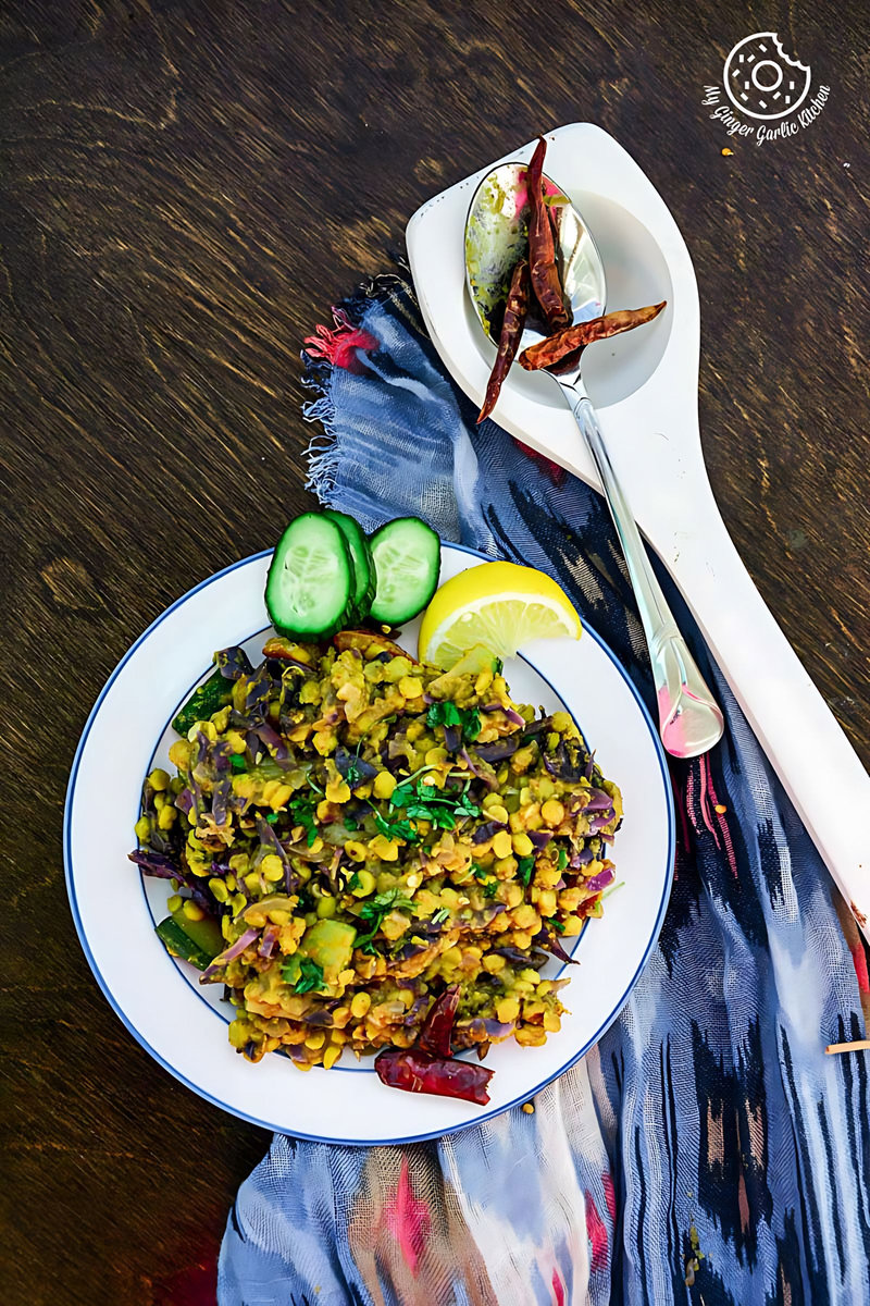 a plate of red cabbage zucchini chana dal with a spoon on a table