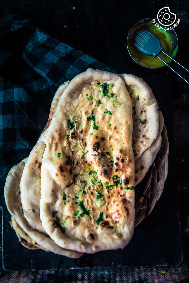 there are four flat breads stacked on a plate with a spoon