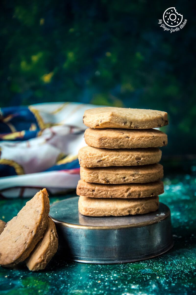 there are a stack of roasted cumin cookies on a plate with a piece of cookie