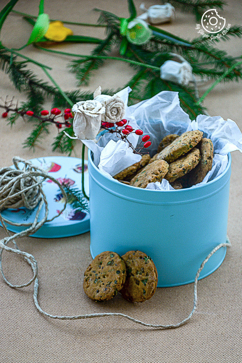 salty sweet whole wheat onion crackers in a blue bucket with a string of twine