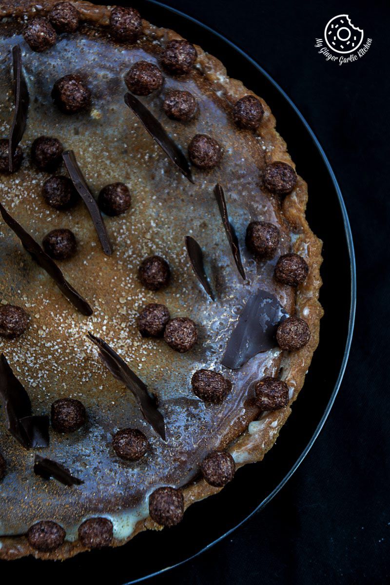 a spiced pumpkin pie with chocolate decorations on it