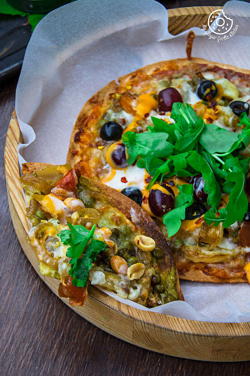 a veggie tortizza or tortilla pizza with cheese, olives, and other toppings on it
