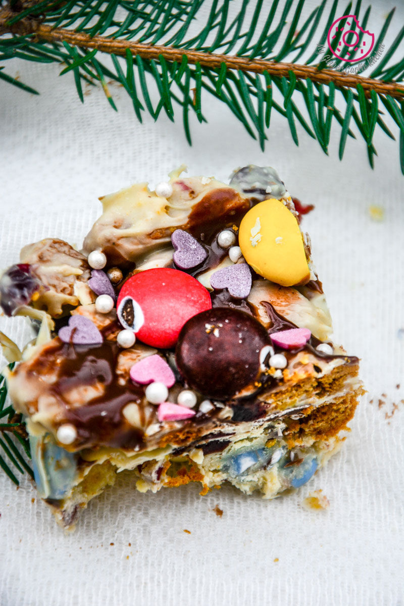 a piece of white christmas rocky road with candies on it