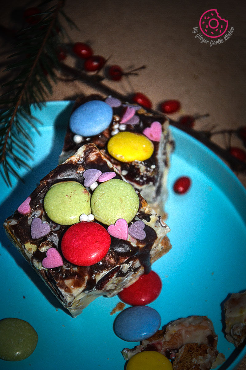 a blue plate with a piece of white christmas rocky road on it