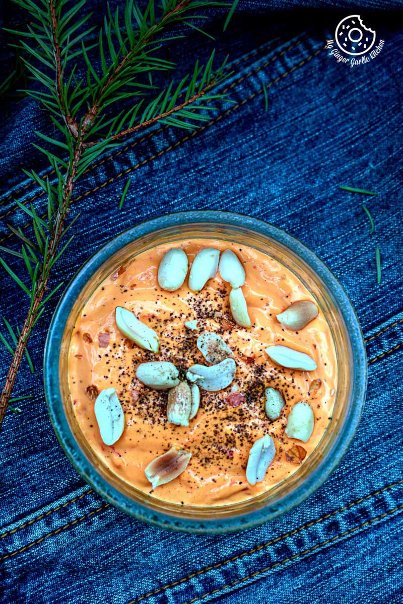 a bowl of figs mayo dip with roasted peanuts on it 