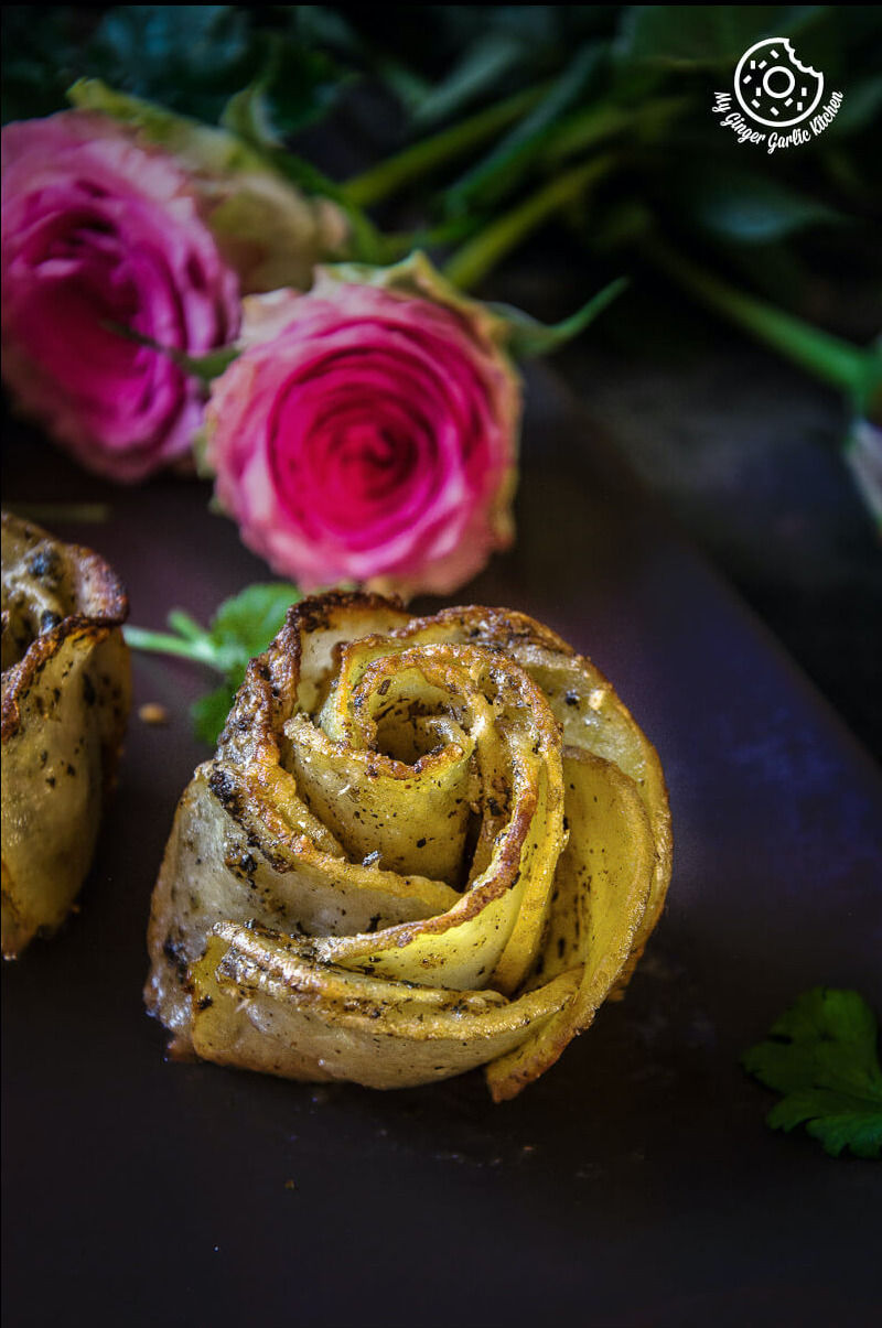 two potato roses and a with some pink roses on a table