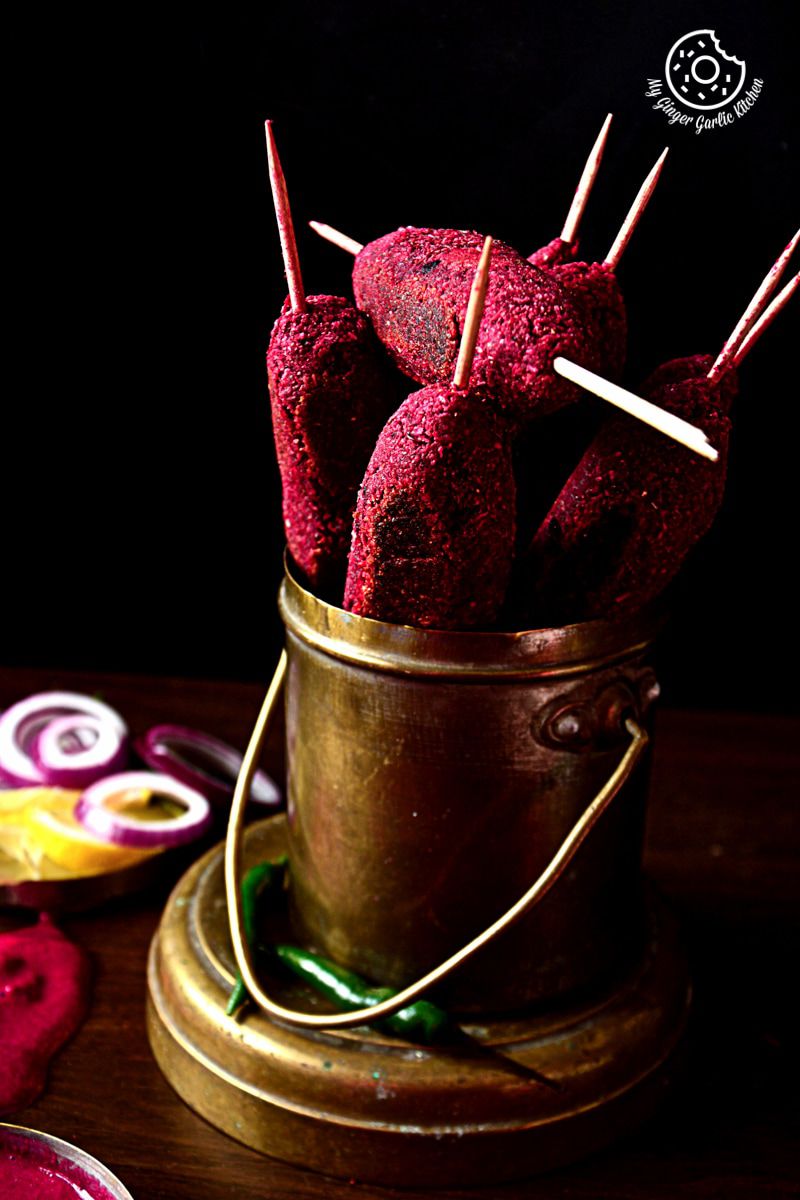 there are some roasted beet kebabs sticking out of a cup