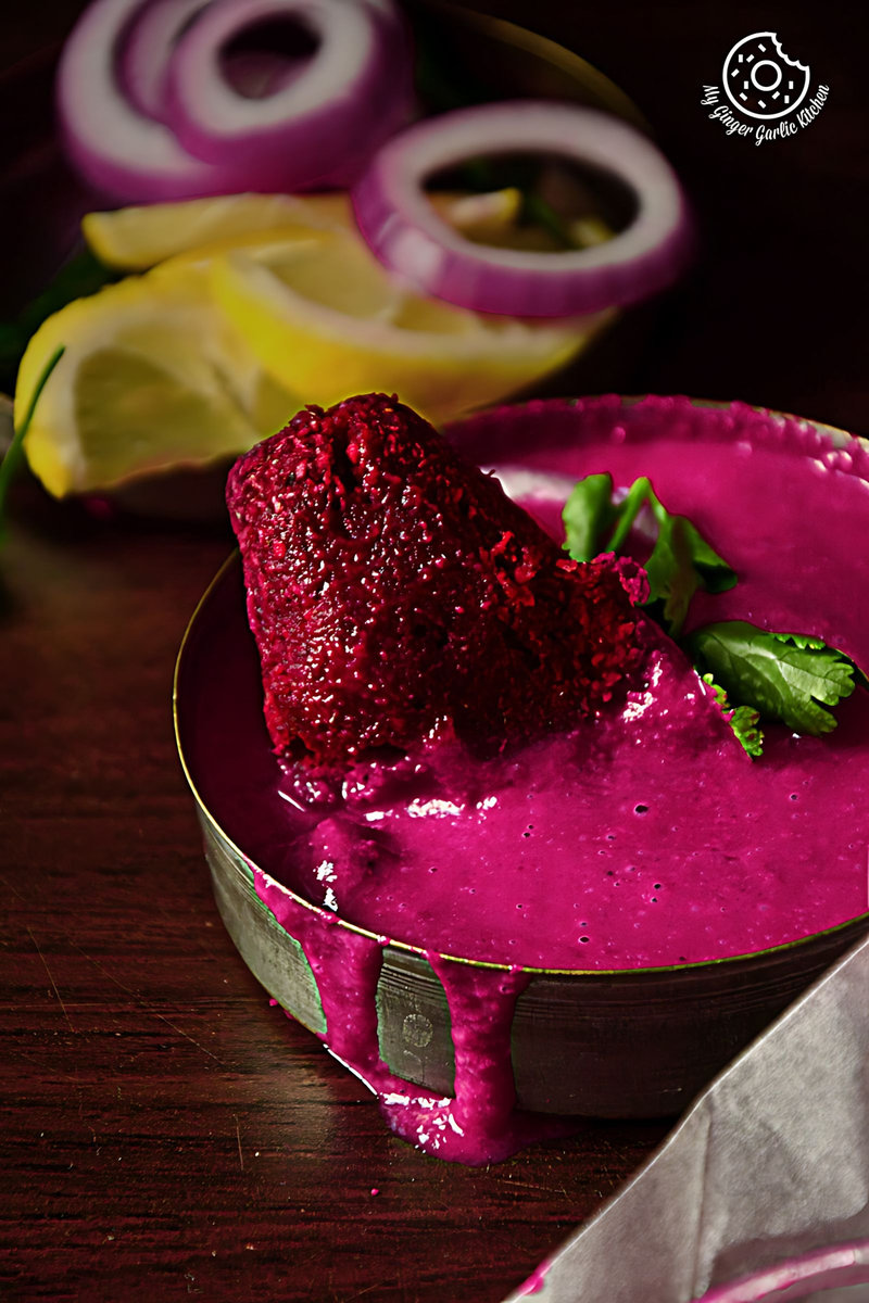 beet sauce with a roasted beet kebab on top of it in a bowl