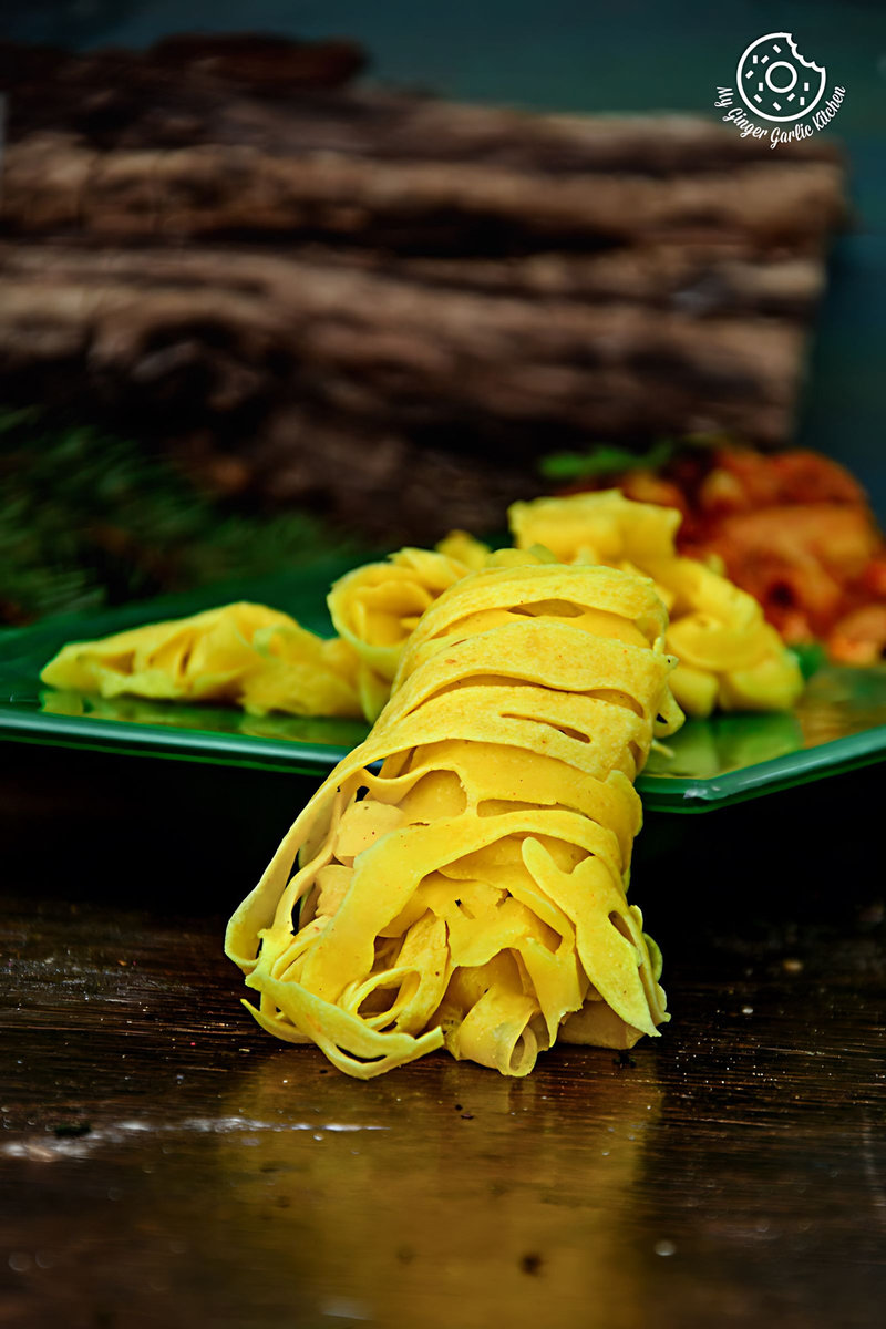 a plate of roti jala and other curry on a table
