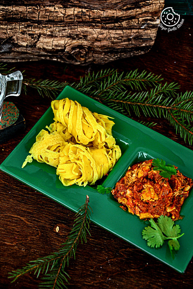 a green plate with roti jala with curry
