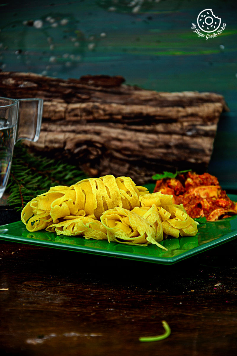 a plate of roti jala with curry on a table