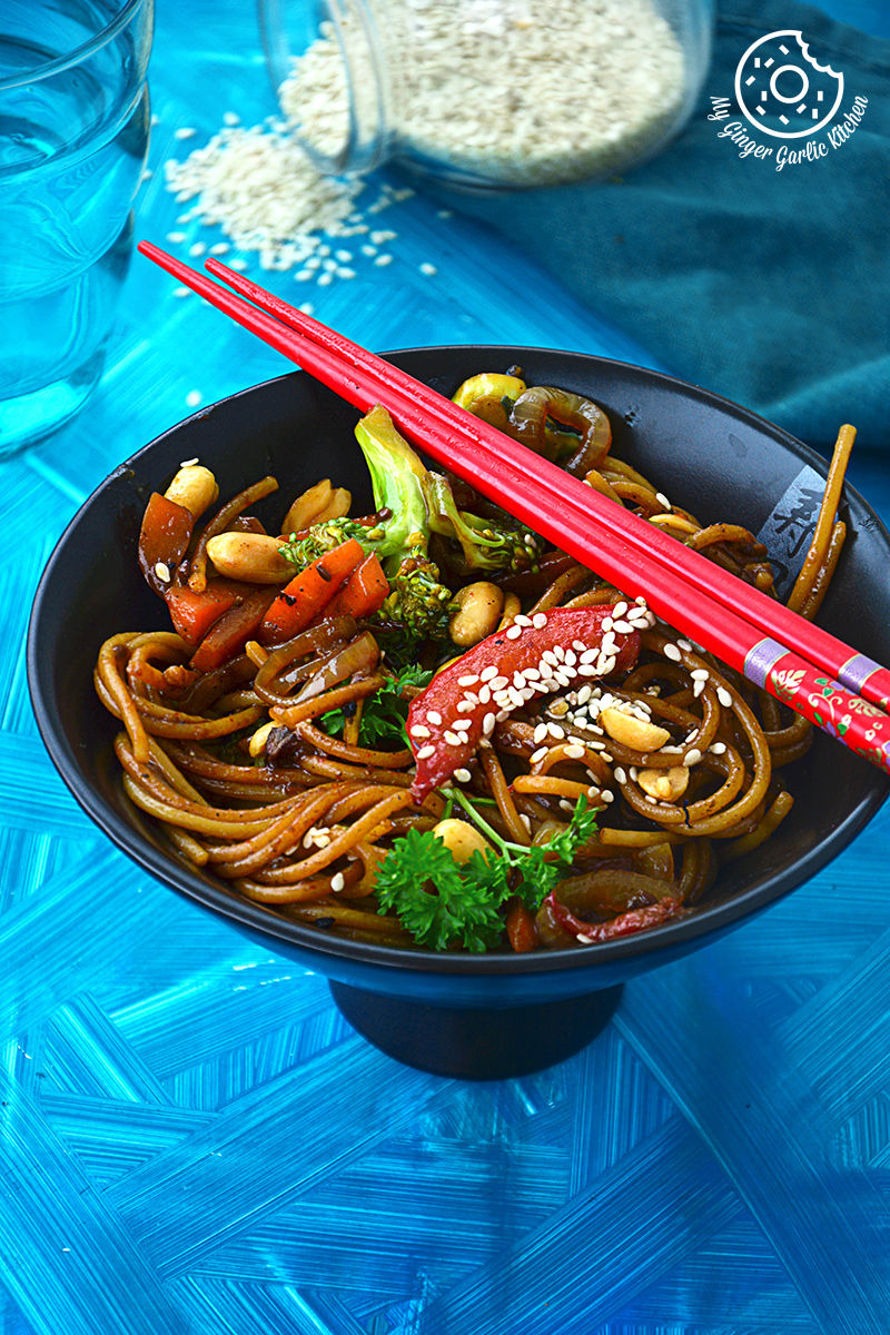 asian vegetable teriyaki noodles with vegetables and vegetables in a bowl with chopsticks