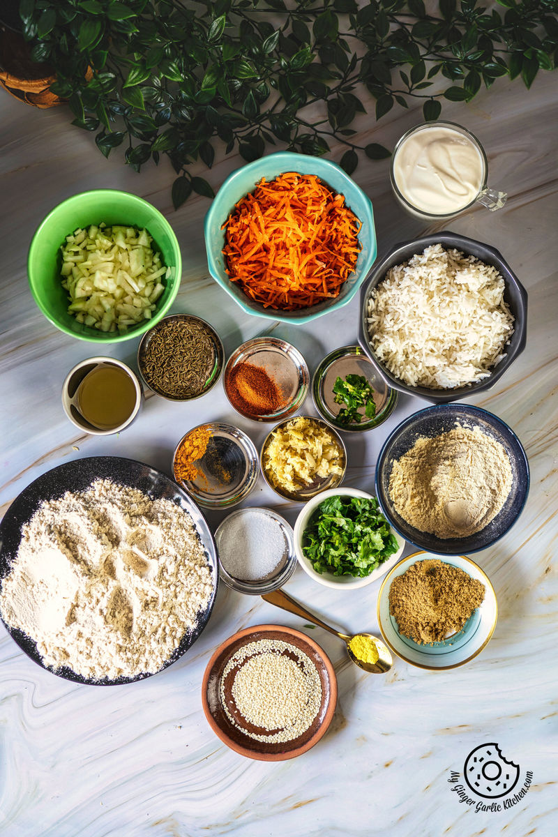 photo of a table with bowls of rice thepla ingredients