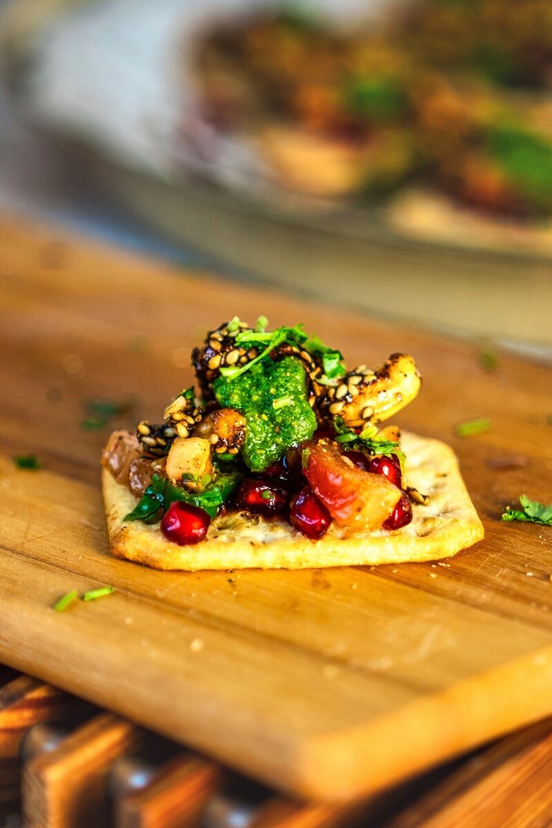 Bowl of roasted cashew chaat mixture with onions, tomatoes, coriander, and pomegranate for Indian chaat recipe