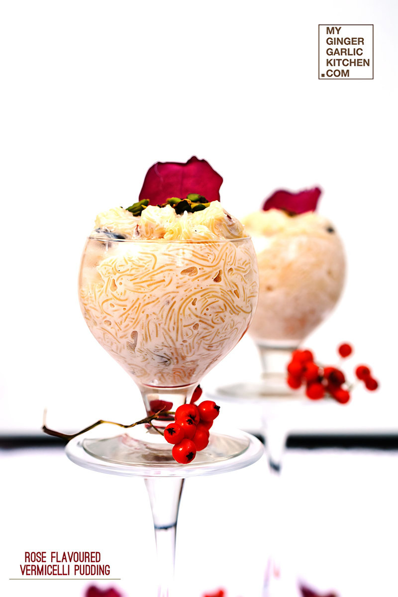 two glasses of rose flavoured vermicelli pudding with dried flowers and pistachios in it