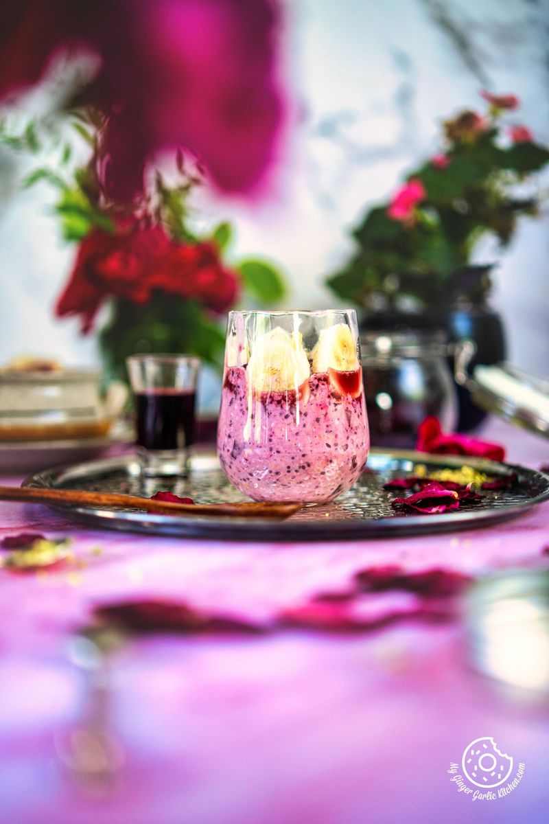 overnight oats with a vase of pink flowers sitting in the background