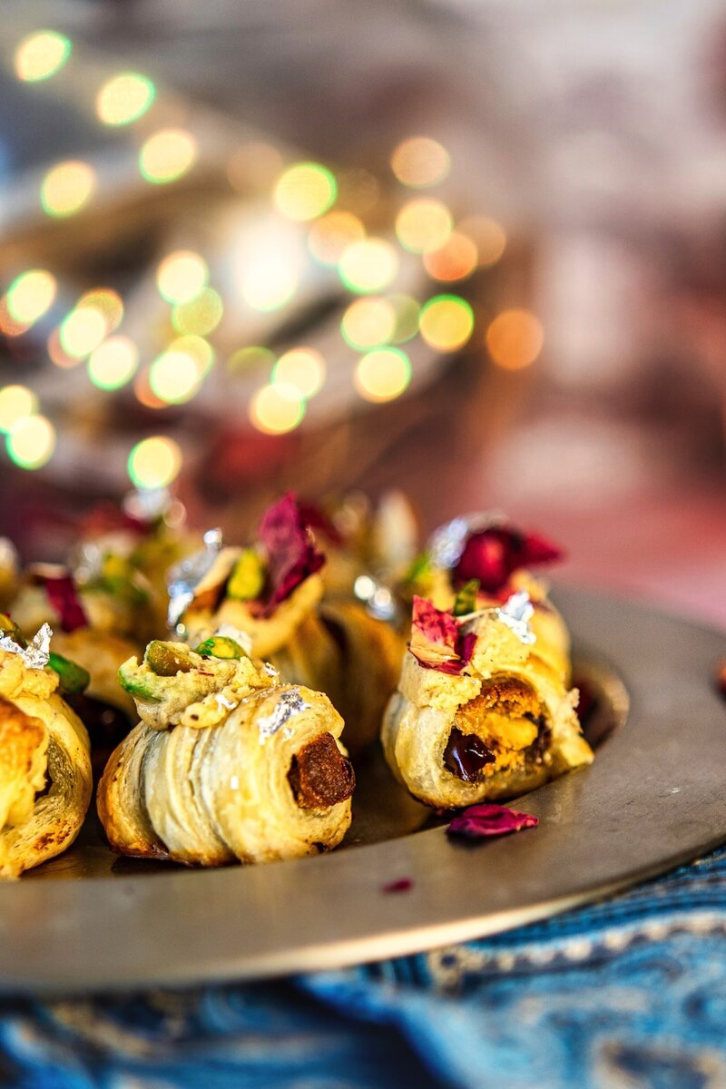 Royal Burfi Date Puff Bites on a festive plate topped with burfi filling nuts and silver leaf, perfect Diwali dessert idea