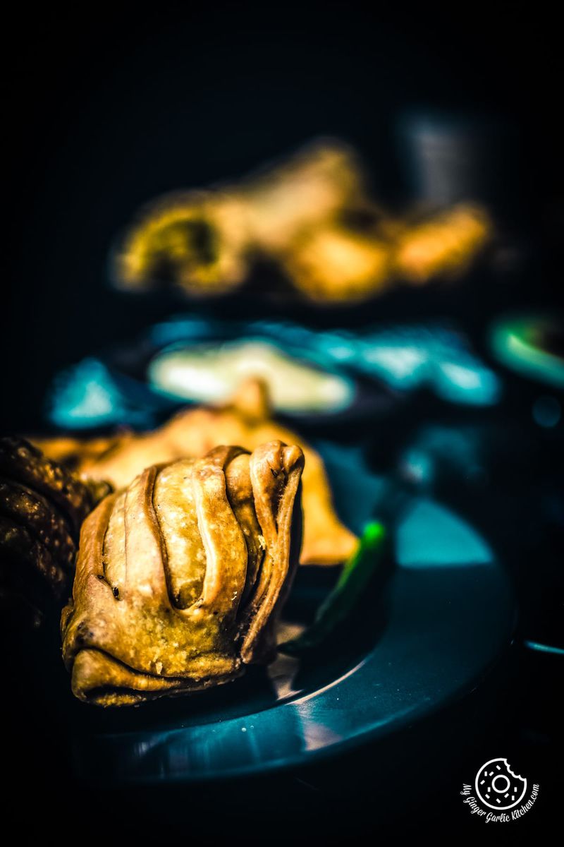 striped aloo samosa served in dark plate