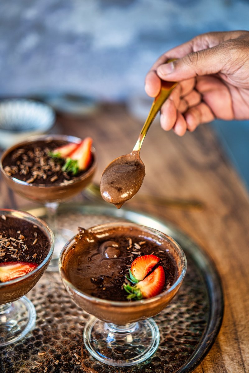 Spoonful of rich silken tofu chocolate pudding showing the thick and creamy texture after chilling