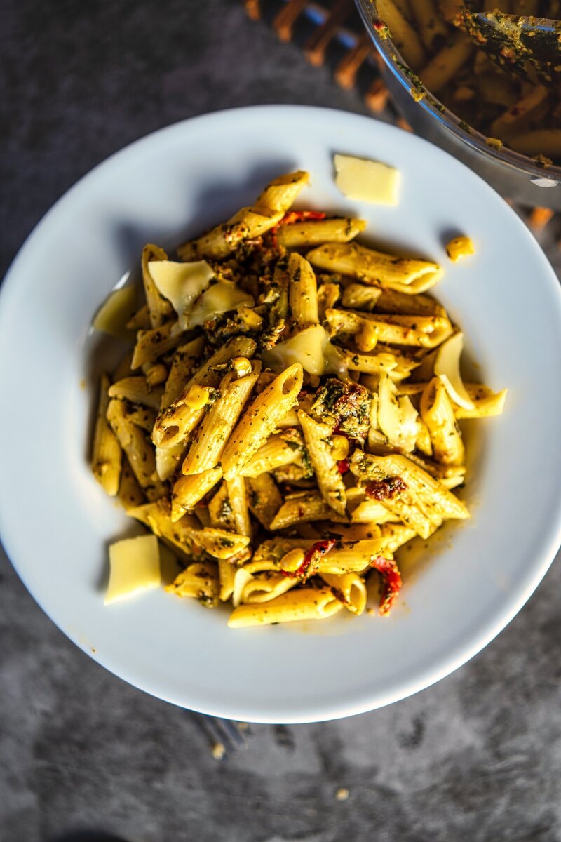 Close-up of spinach sun-dried tomato penne pasta with corn, creamy style vegetarian pasta recipe