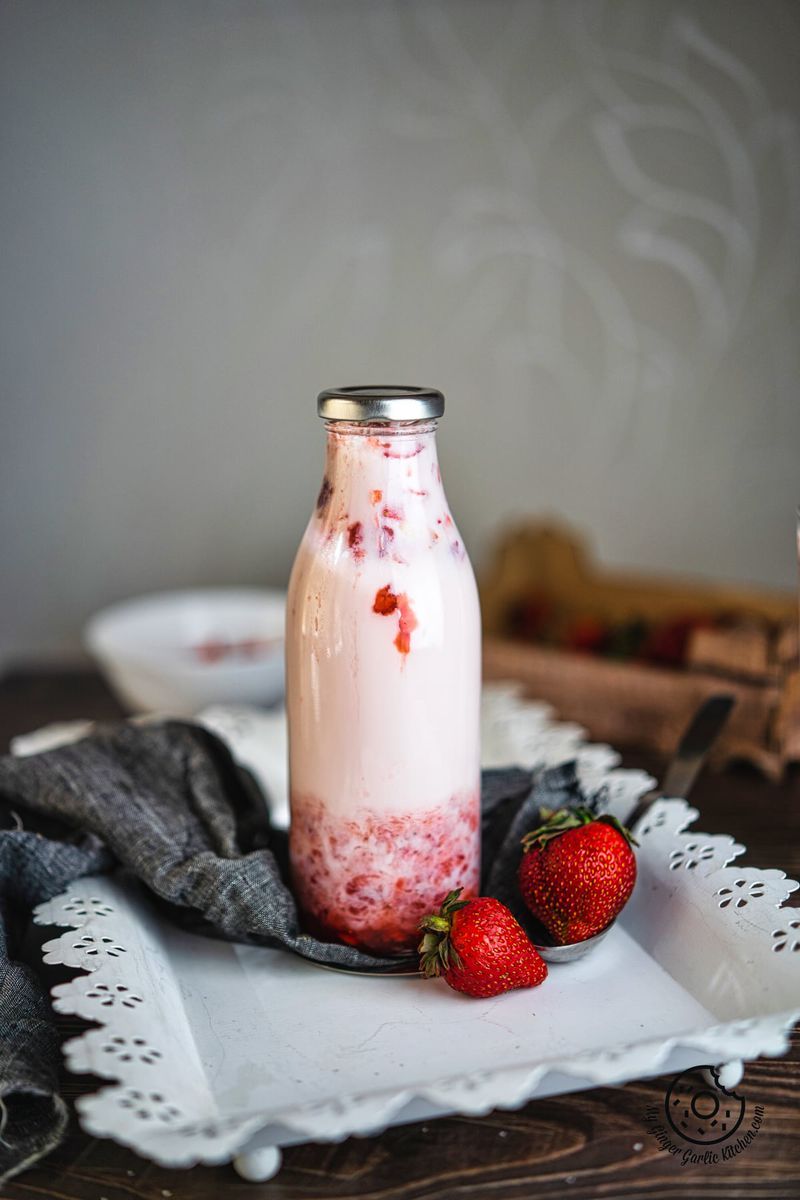 korean strawberry milk bottle with two strawberries