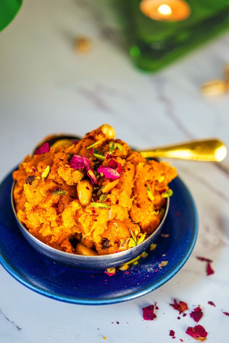 Traditional shakarkandi halwa recipe topped with cashews and saffron served warm in authentic Indian katori bowl