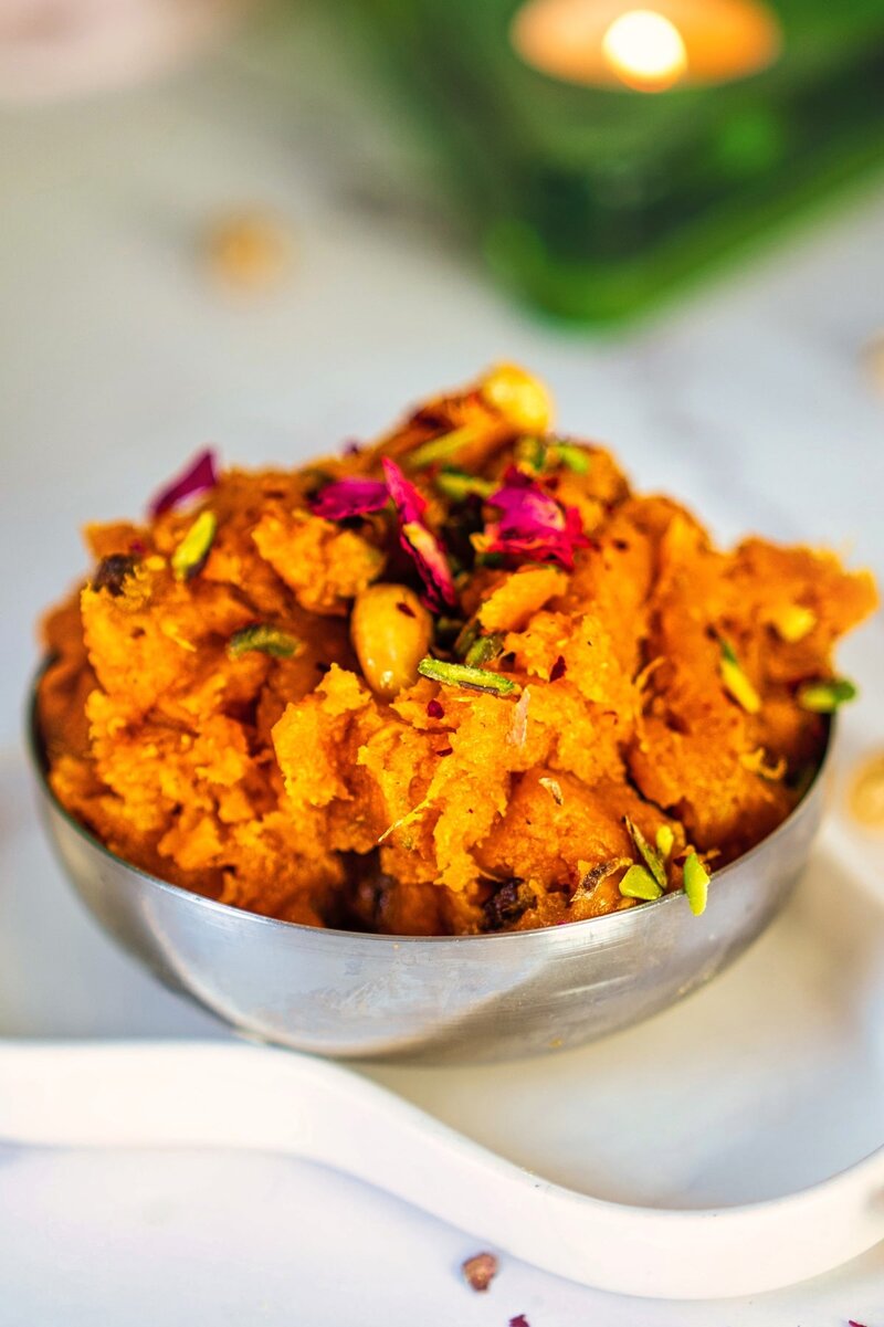 Rich and creamy shakarkandi halwa with golden texture, garnished with roasted nuts for special occasion dessert