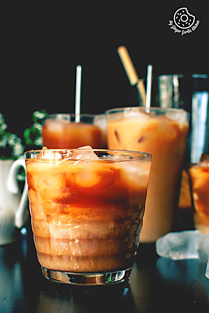 many glasses of thai iced tea on a table