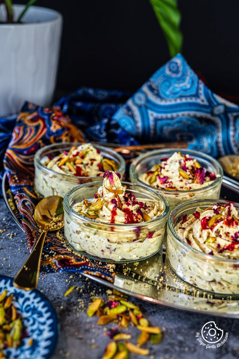 closeup shot of thandai shrikhand served in transparent bowls