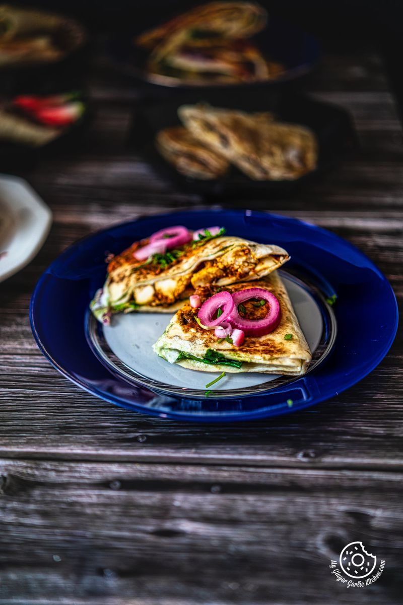 butter paneer tortilla wrap served in a white and blue glass plate