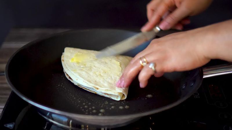 Image of the recipe cooking step-6-6 for TikTok Tortilla Wrap Hack (6 Vegetarian Filling Ideas)