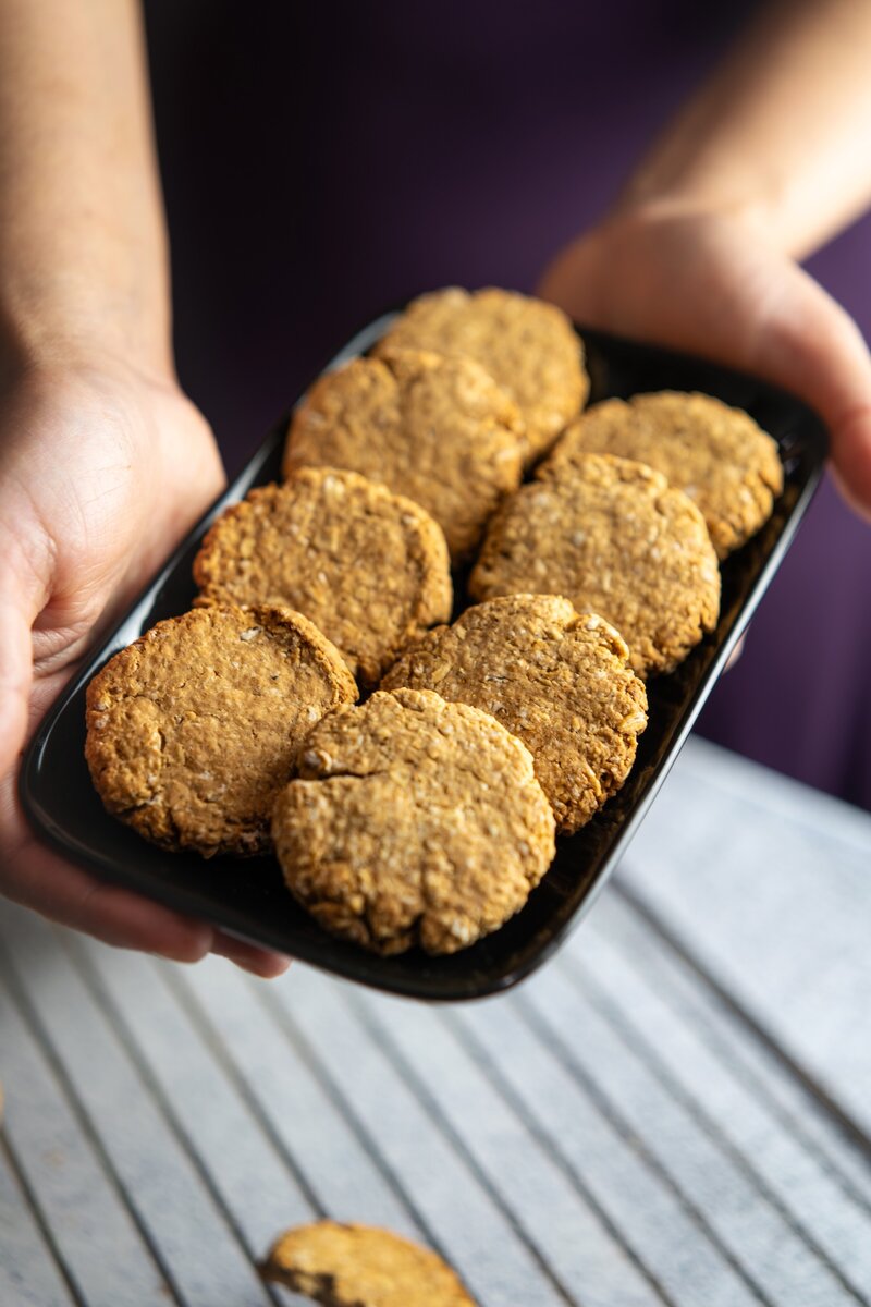 Beautifully styled vegan oatmeal cookies on a black plate, soft and chewy dairy free oat cookies perfect for snacking.