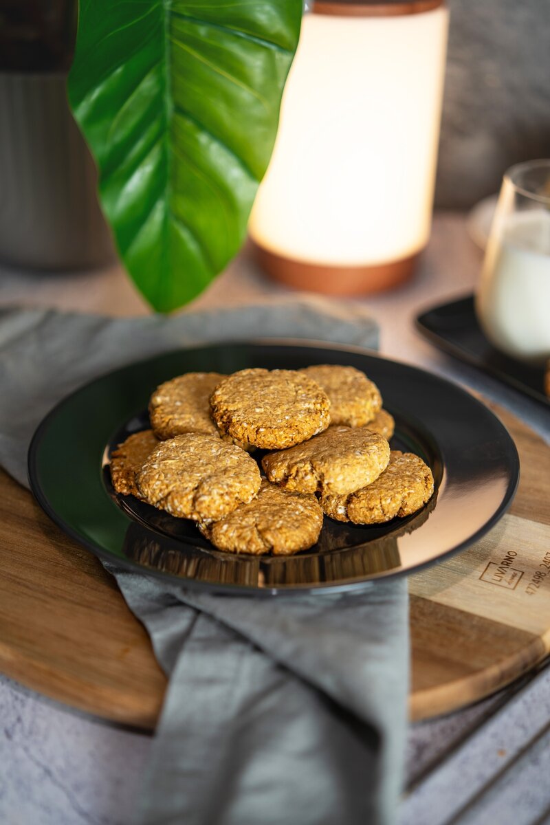 Plate of homemade vegan oatmeal cookies held in hands, crispy and chewy gluten free oatmeal cookies.