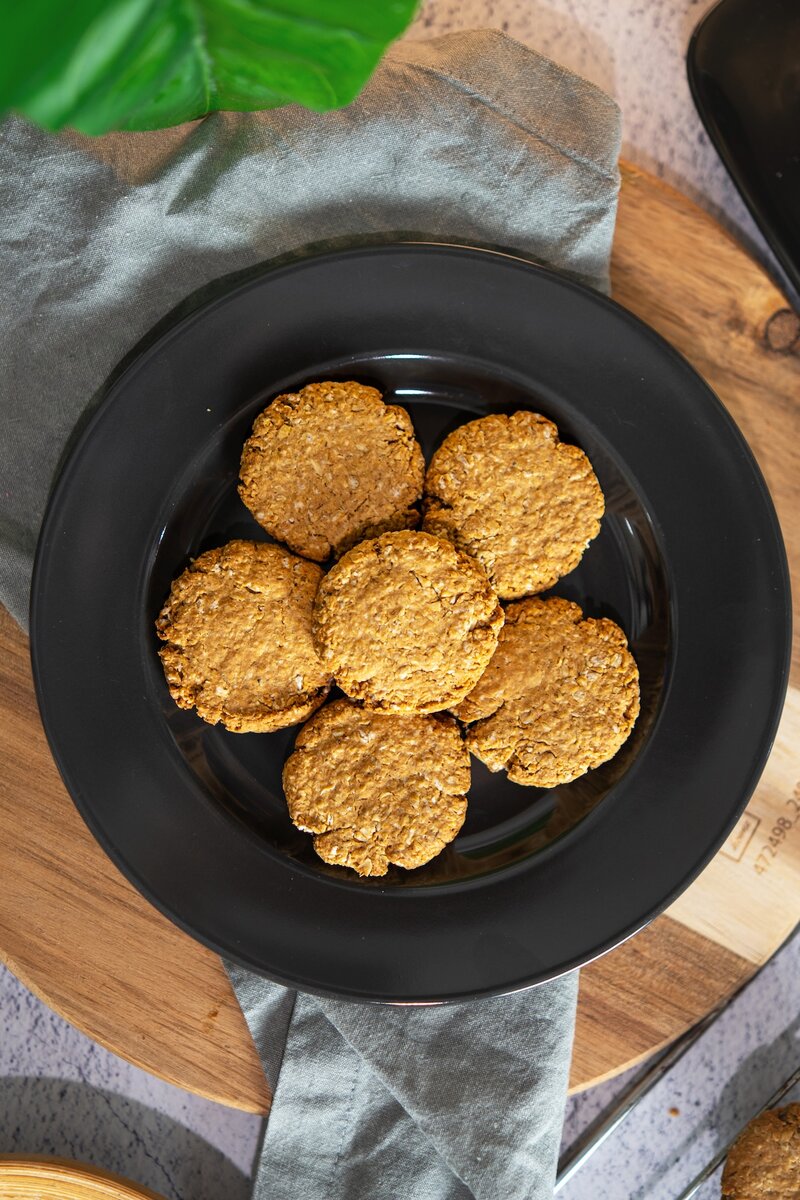 Freshly baked vegan oatmeal cookies on a cooling rack, easy gluten free oat cookies made without flour or refined sugar.