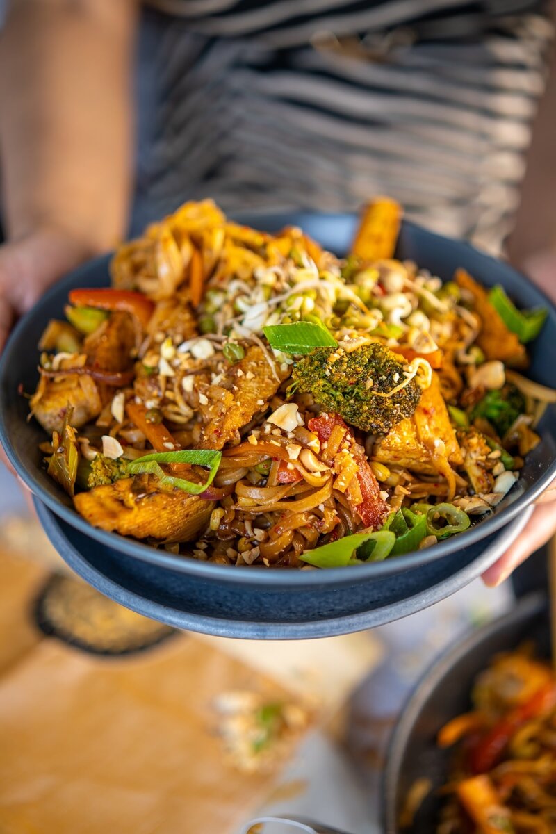 Vegan Pad Thai with tofu, fresh vegetables, and crushed peanuts, a flavorful and high protein plant based Thai noodle recipe.