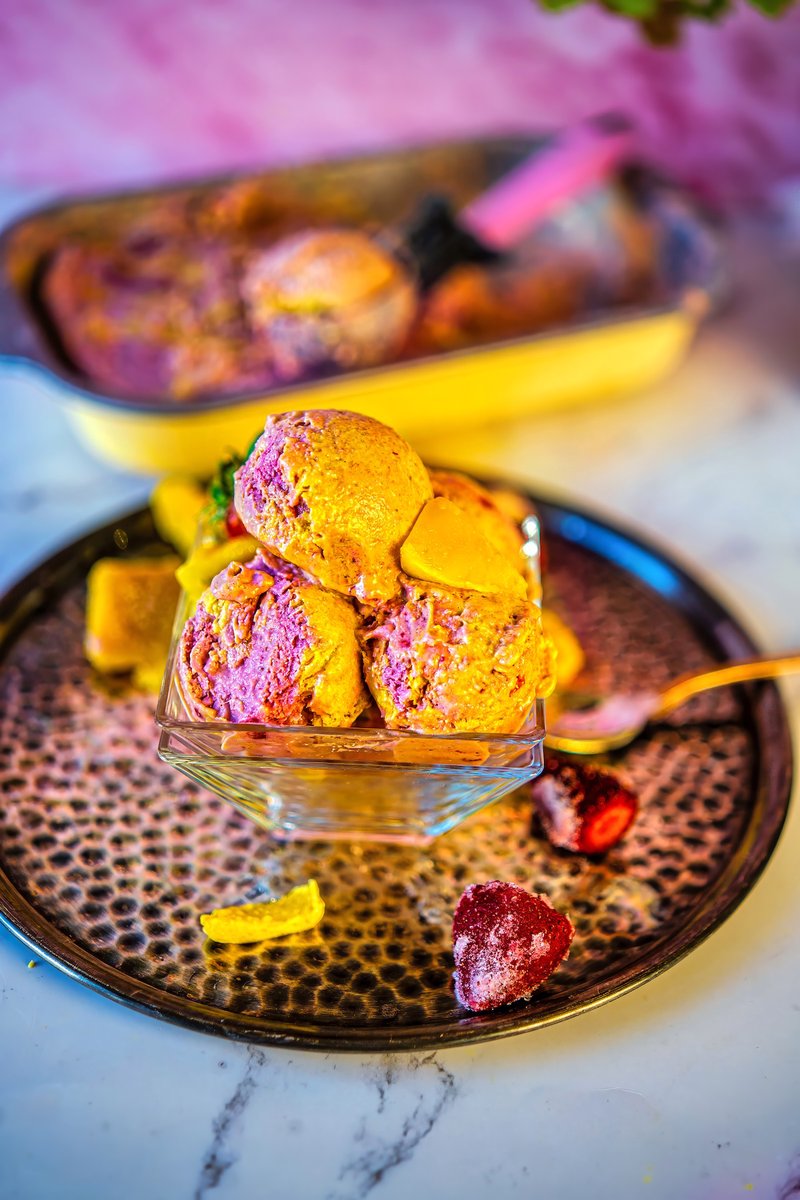 Scoops of Vegan Strawberry Mango Ice Cream served in a dessert bowl with fresh strawberries and mango chunks