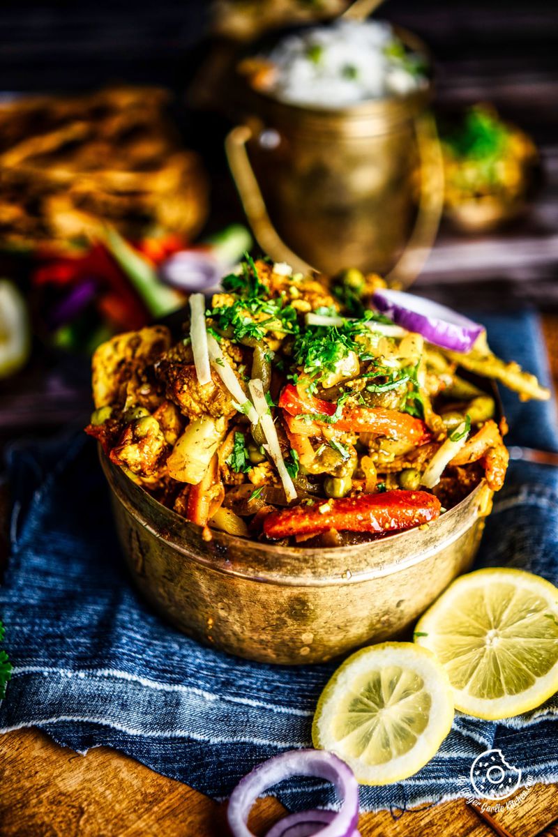 vegetable jalfrezi served in a brass bowl
